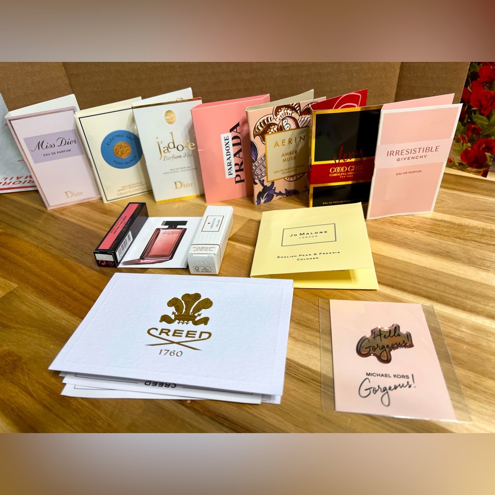11 women’s fragrance deluxe samples and 1 scented phone sticker